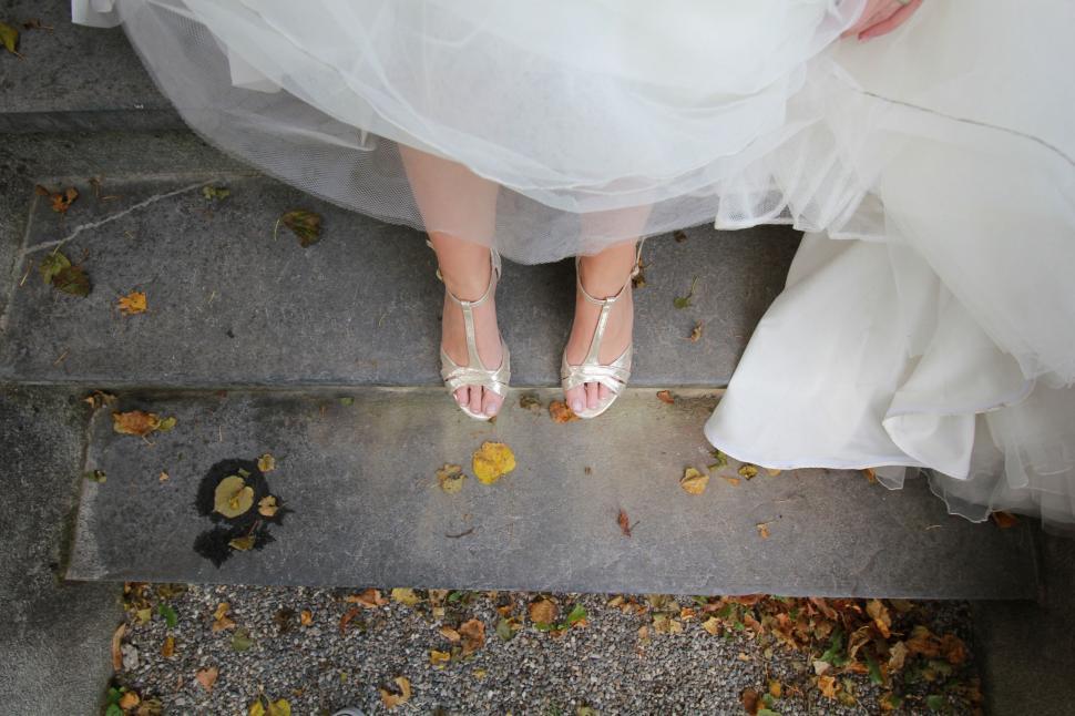 Free Image of Woman in Wedding Dress Standing on Steps 