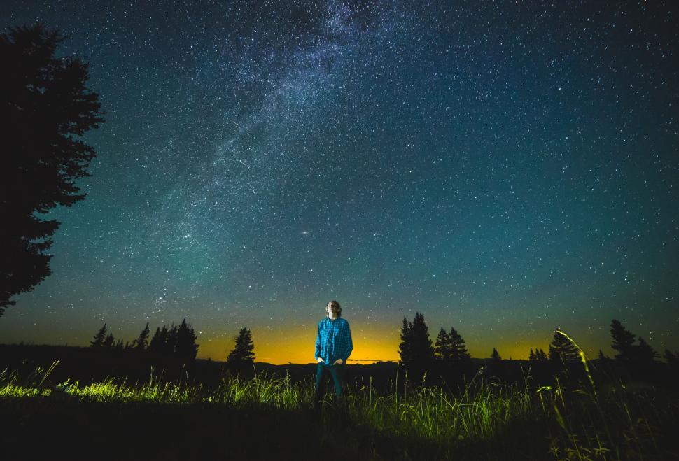 Free Image of Man Standing in Field Under Starry Night Sky 