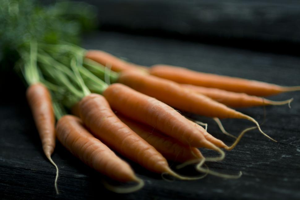 Free Image of Carrots Arranged on Wooden Table 