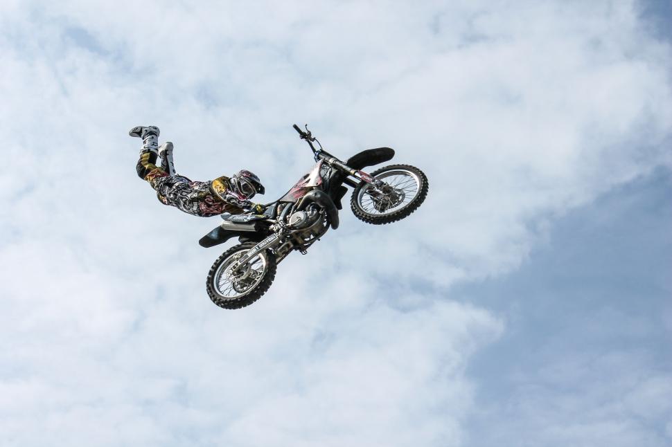 Free Image of Man Riding Motorcycle Flying Through the Air 
