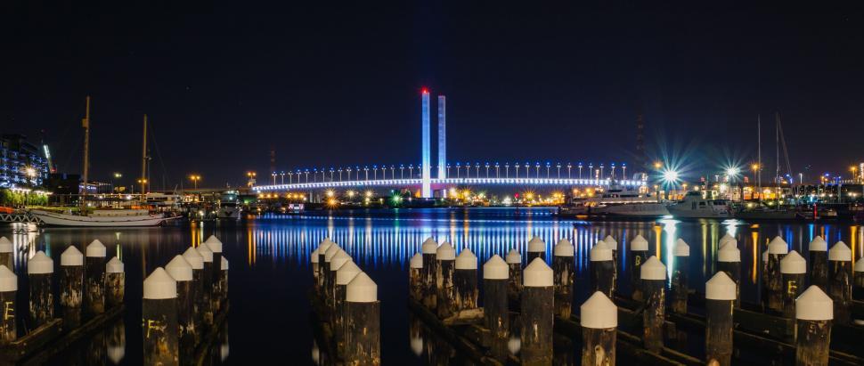 Free Image of Night View of Harbor With Bridge in Background 