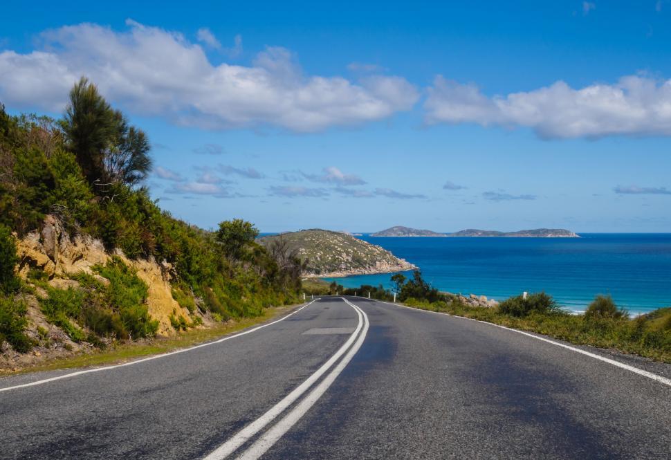 Free Image of Empty Road Along Ocean on Sunny Day 
