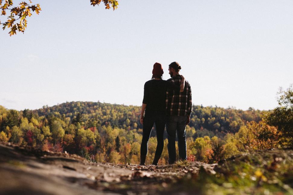 Free Image of Two People Standing on Top of a Hill 