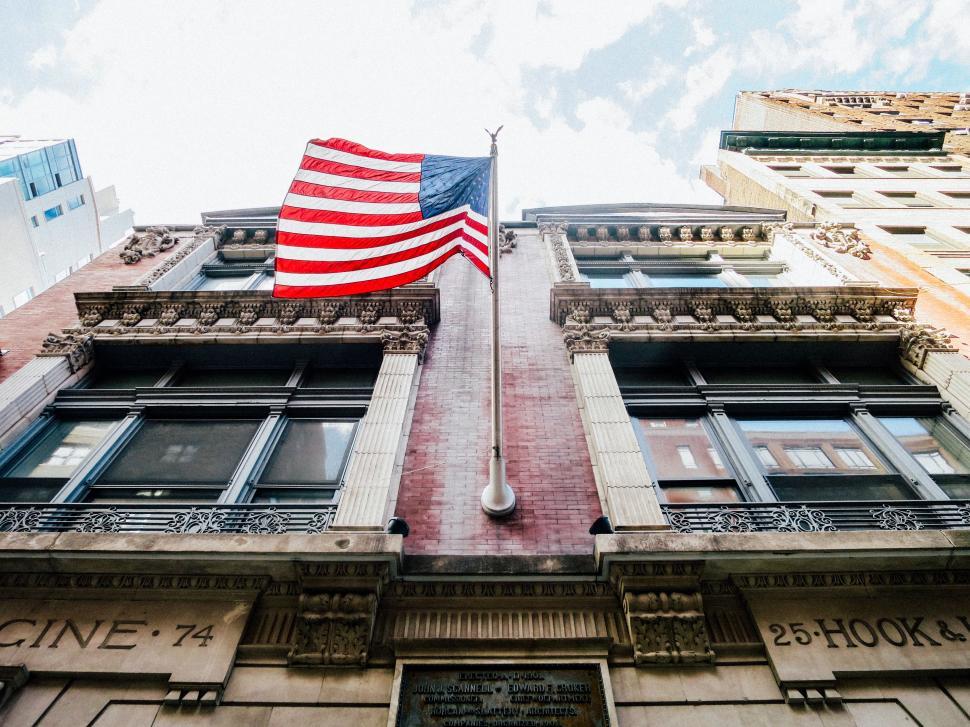 Free Image of Large American Flag Displayed on Side of Building 