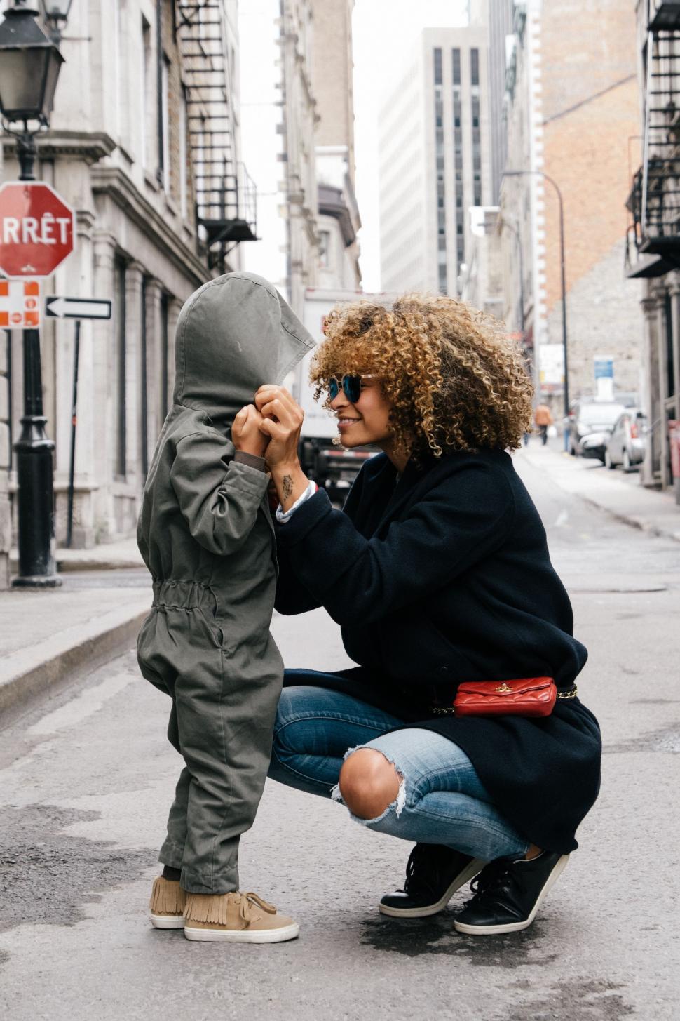 Free Image of Woman Kneeling Down Next to Little Boy 