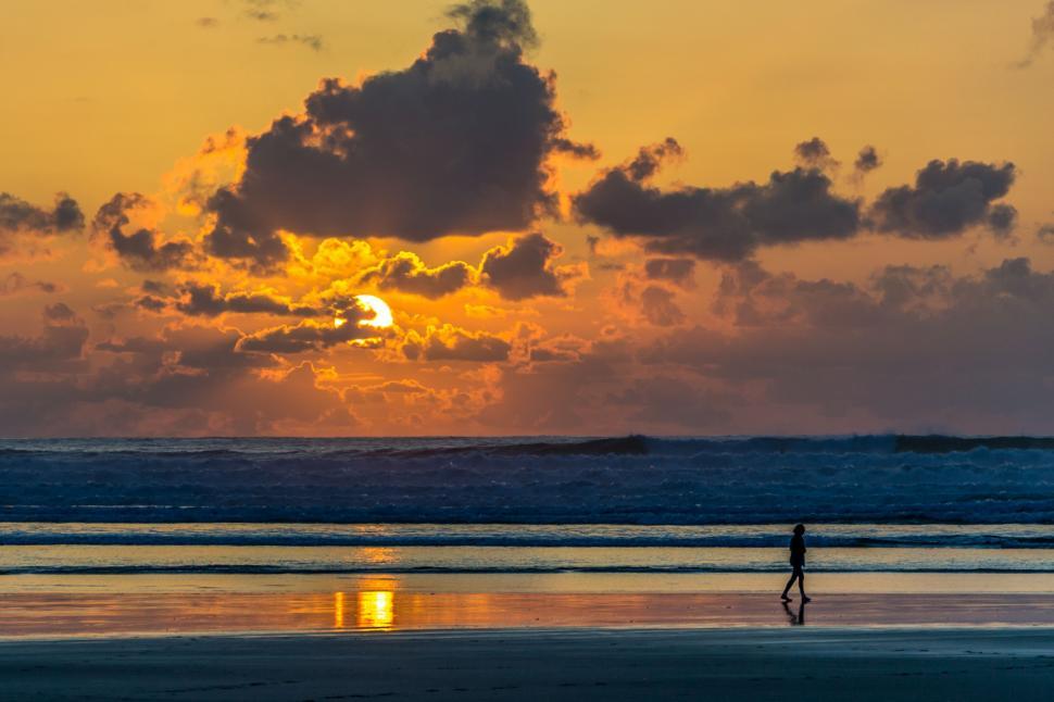 Free Image of Person Walking on Beach at Sunset 