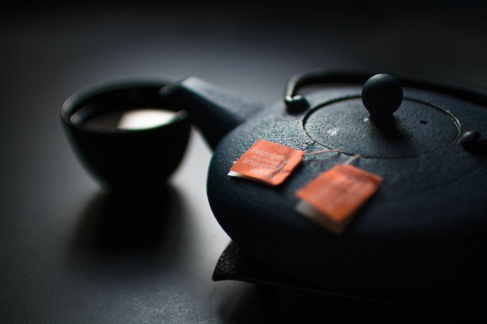 Free Image of Black Teapot With Red Patch 