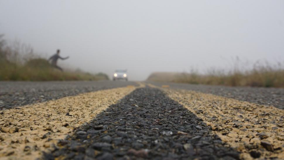 Free Image of Person Standing on Foggy Day Road 