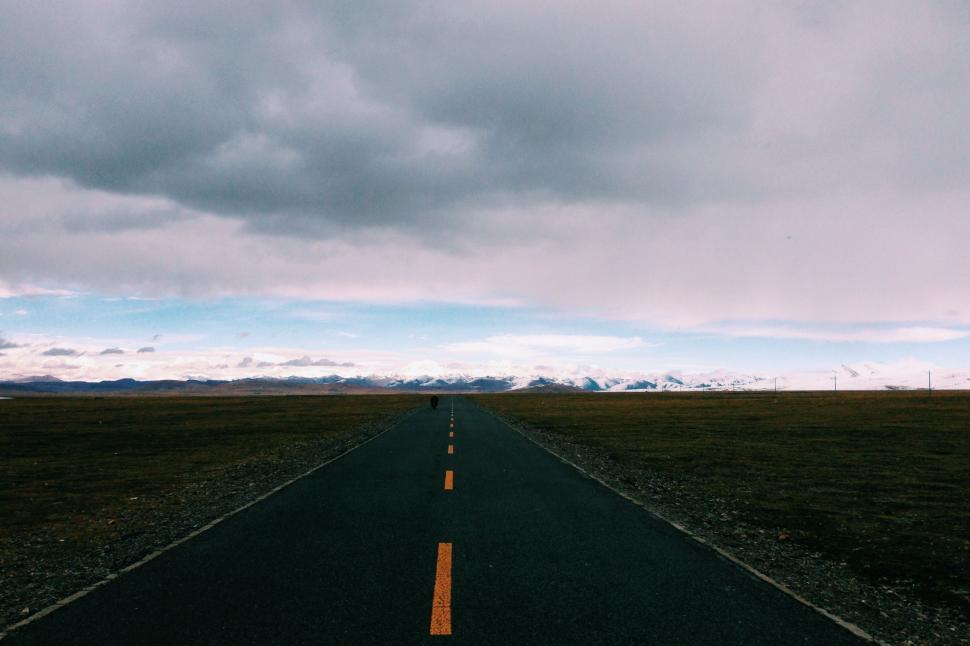 Free Image of Endless Road Under Cloudy Sky 