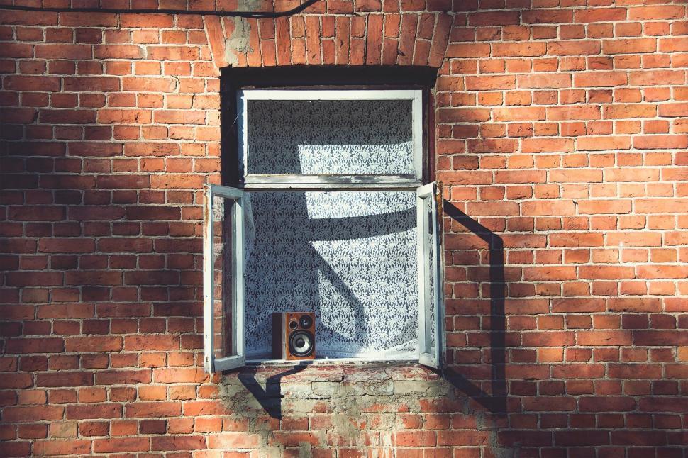 Free Image of Brick Wall With Window and Camera 