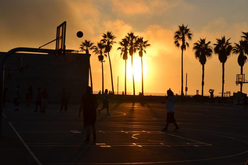 Free Image of Group of People Playing a Game of Basketball 