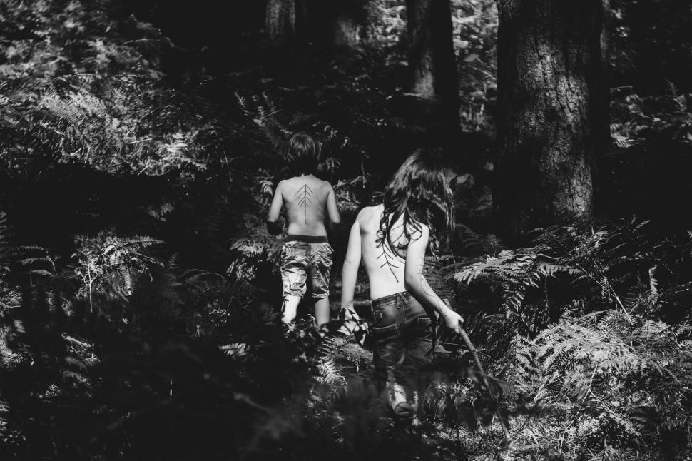 Free Image of Couple Walking Through Forest 