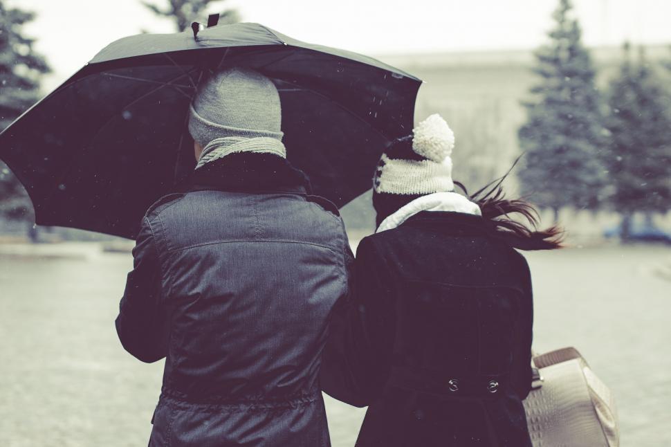 Free Image of Couple Standing Under Umbrella 