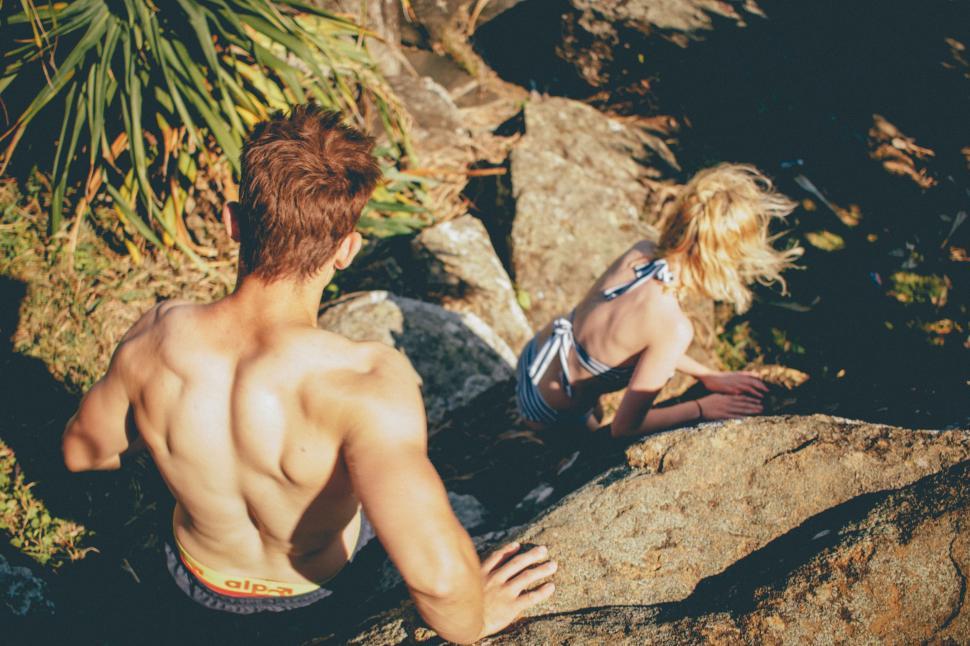Free Image of Couple Sitting on Rocks 