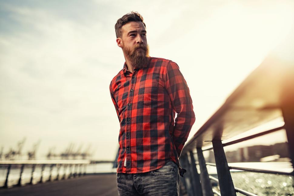 Free Image of Man With Beard Standing on Bridge 