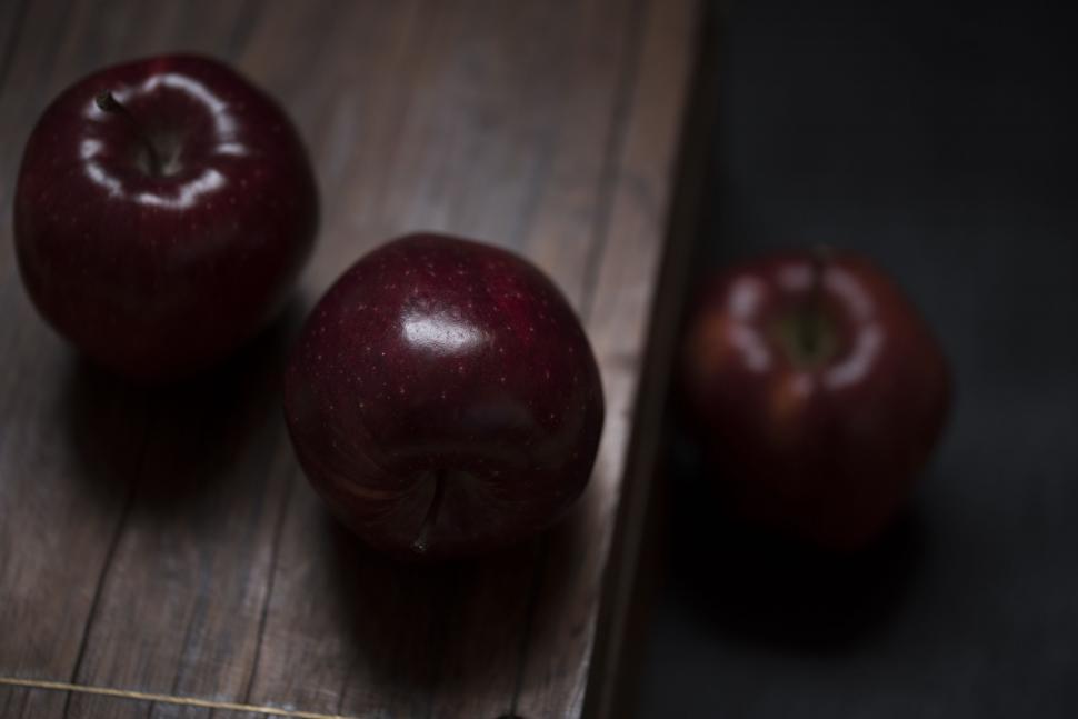 Free Image of Three Apples on Wooden Cutting Board 