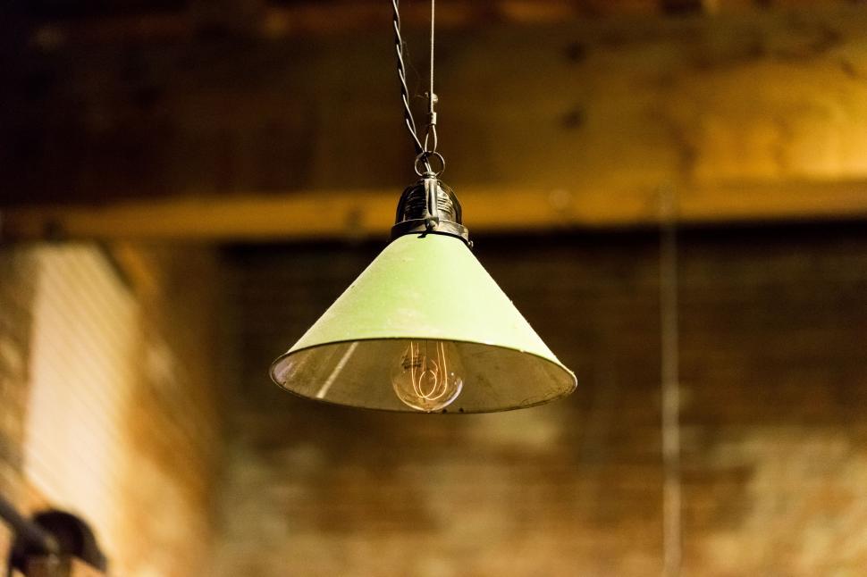 Free Image of Light Fixture Hanging From Brick Wall 