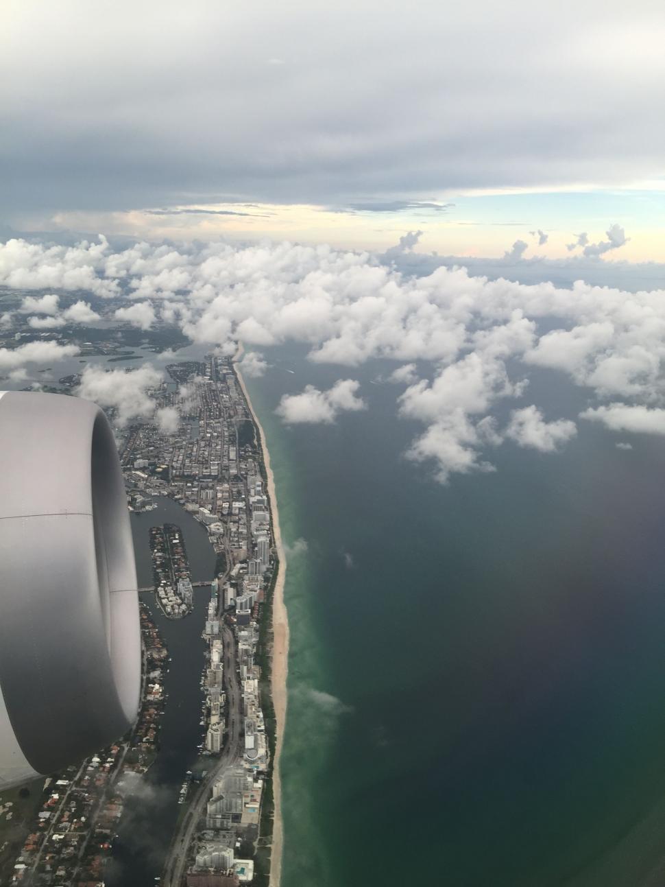 Free Image of Aerial View of Airplane Wing Flying Over City 