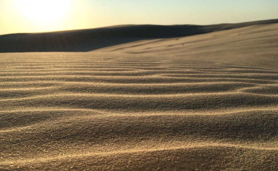 Free Image of Sun Setting Over Sand Dunes 