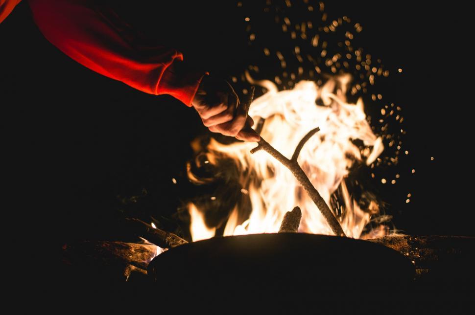 Free Image of Person Stirring Pot Over Fire 