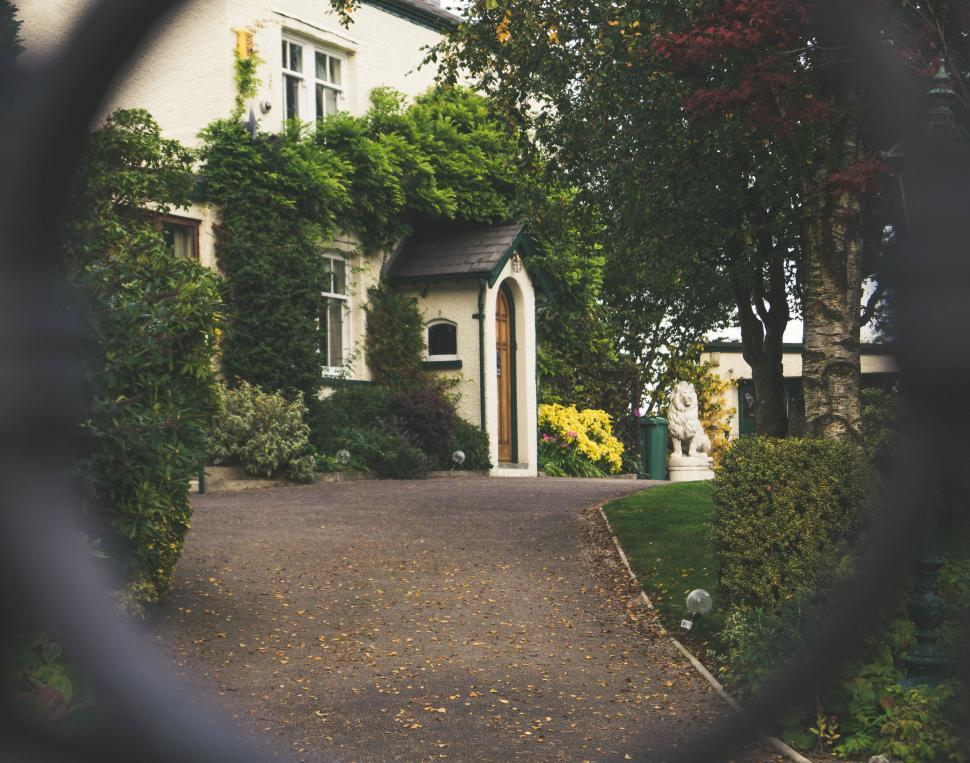 Free Image of House Seen Through Fence, Another House in Background 