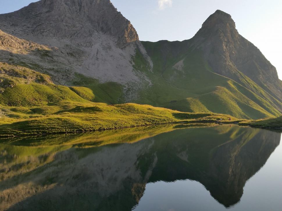 Free Image of Mountain Range Reflected in Still Lake 