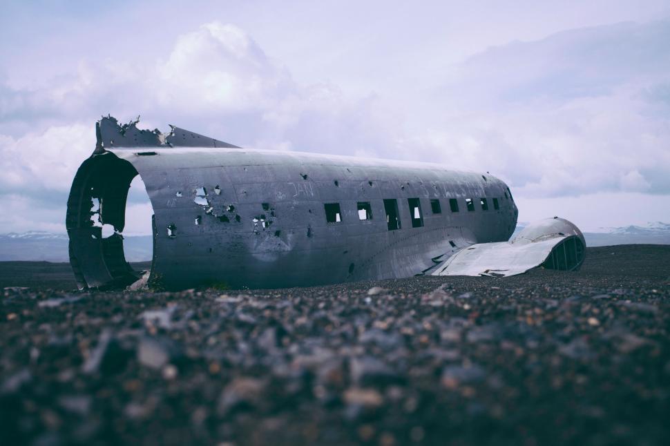 Free Image of Old Airplane Resting on Rocky Field 