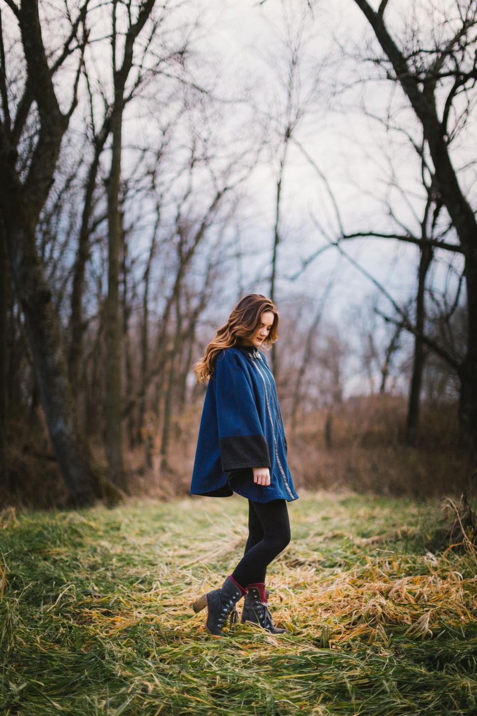 Free Image of Woman in Blue Cape Standing in Field 