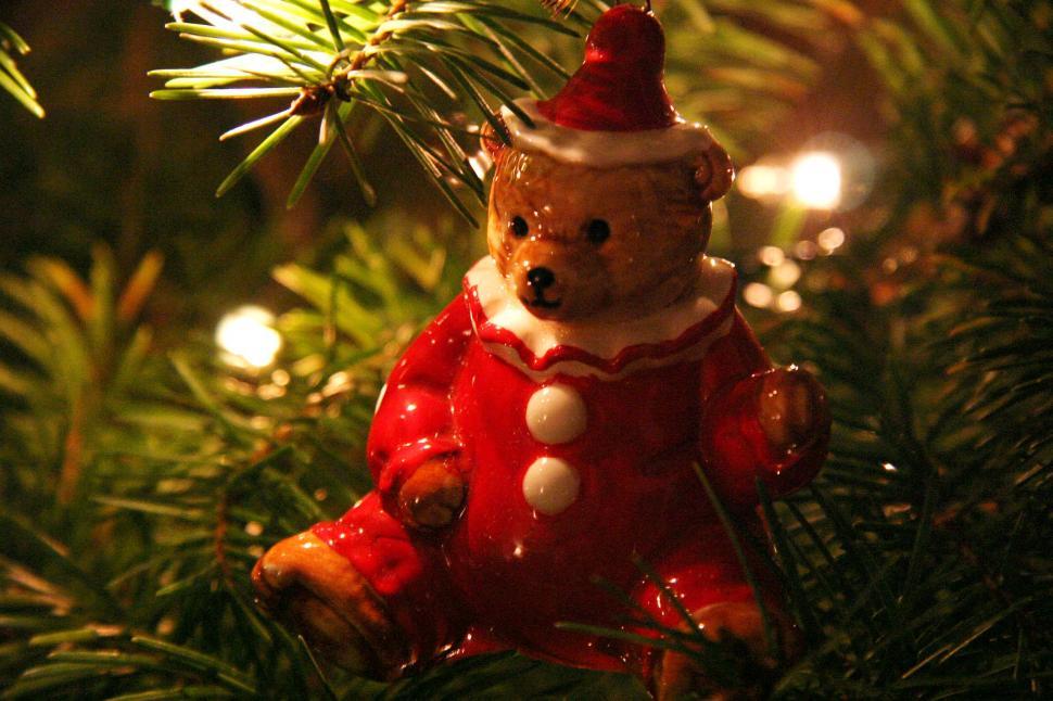 Free Image of Teddy Bear Ornament Hanging From a Christmas Tree 