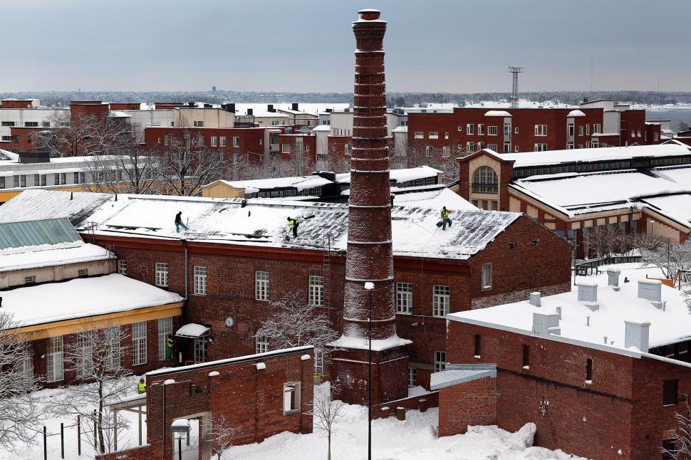 Free Image of Snowy View of a Brick Building With a Chimney 