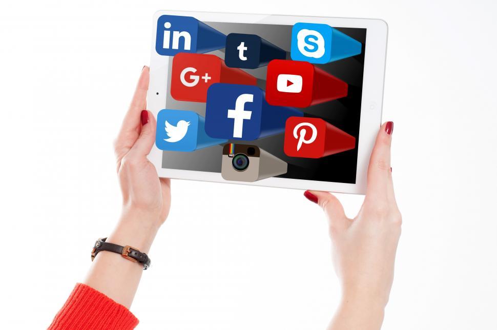 Free Image of Woman Holding Tablet with Social Media Networks Logos 