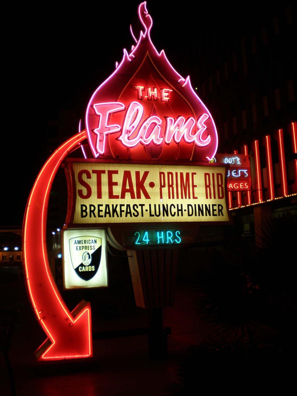 Free Image of Neon Sign: The Flame Steak Prime Rib and Breakfast Lunch Diner 