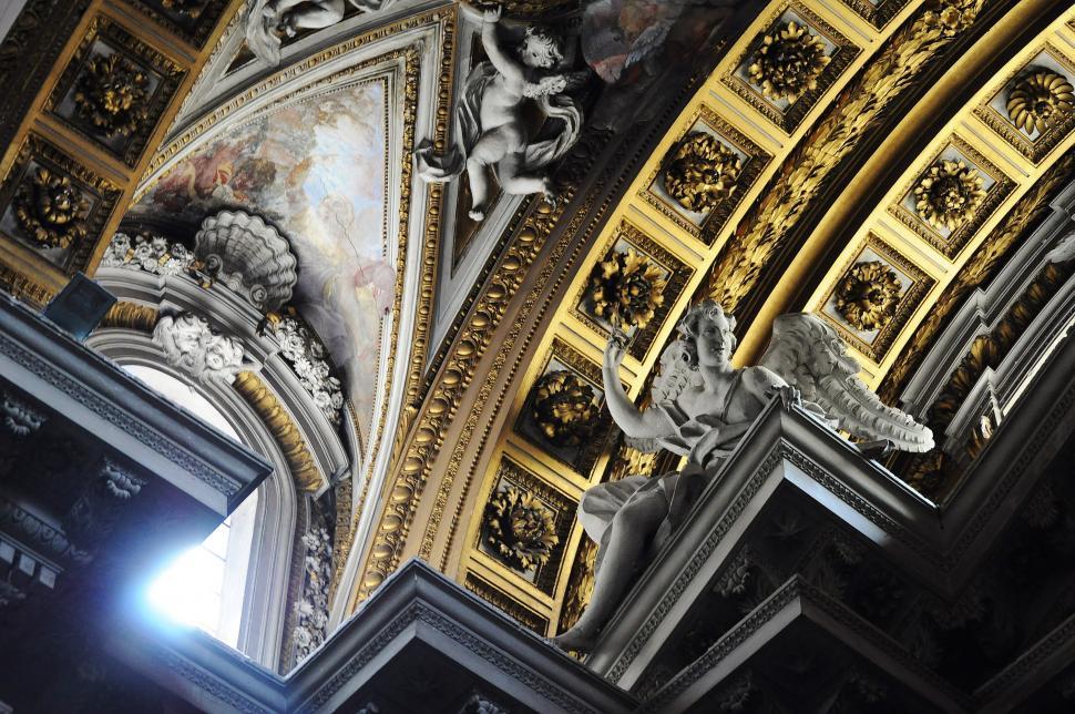Free Image of Ornate Gold and White Ceiling Decorations in Building 