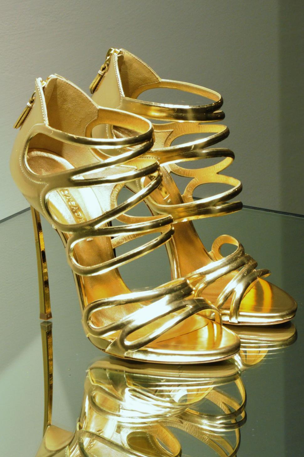 Free Image of Gold High Heels on Glass Table 