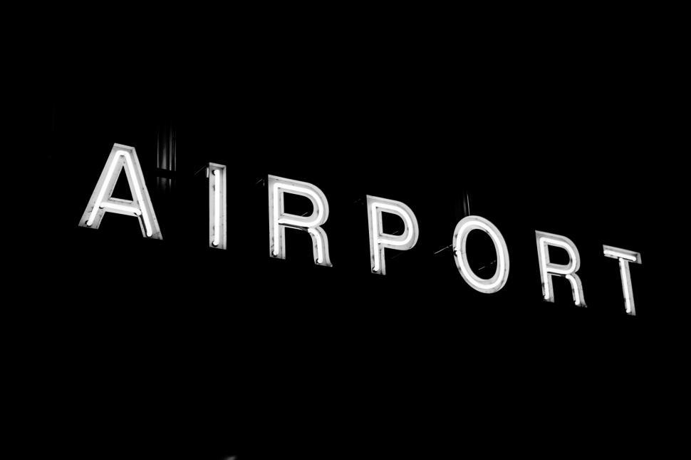Free Image of Black and White Photo of Airport Sign 