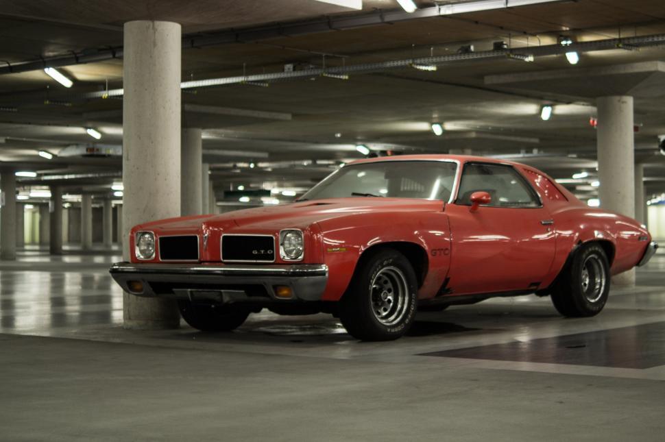 Free Image of Red Car Parked in Parking Garage 