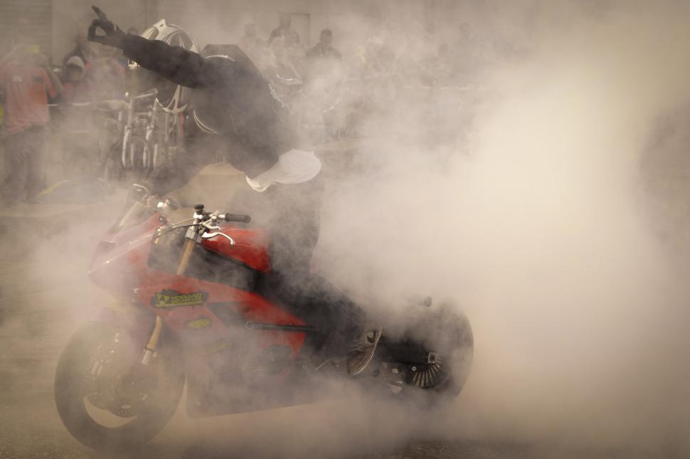 Free Image of Person Riding Motorcycle on Foggy Street 