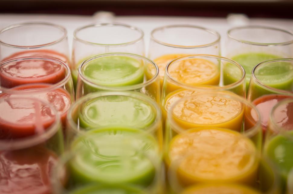 Free Image of Row of Glasses Filled With Different Colored Liquids 