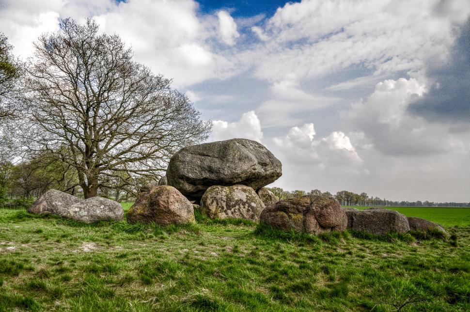 Free Image of Large Rock on Lush Green Field 
