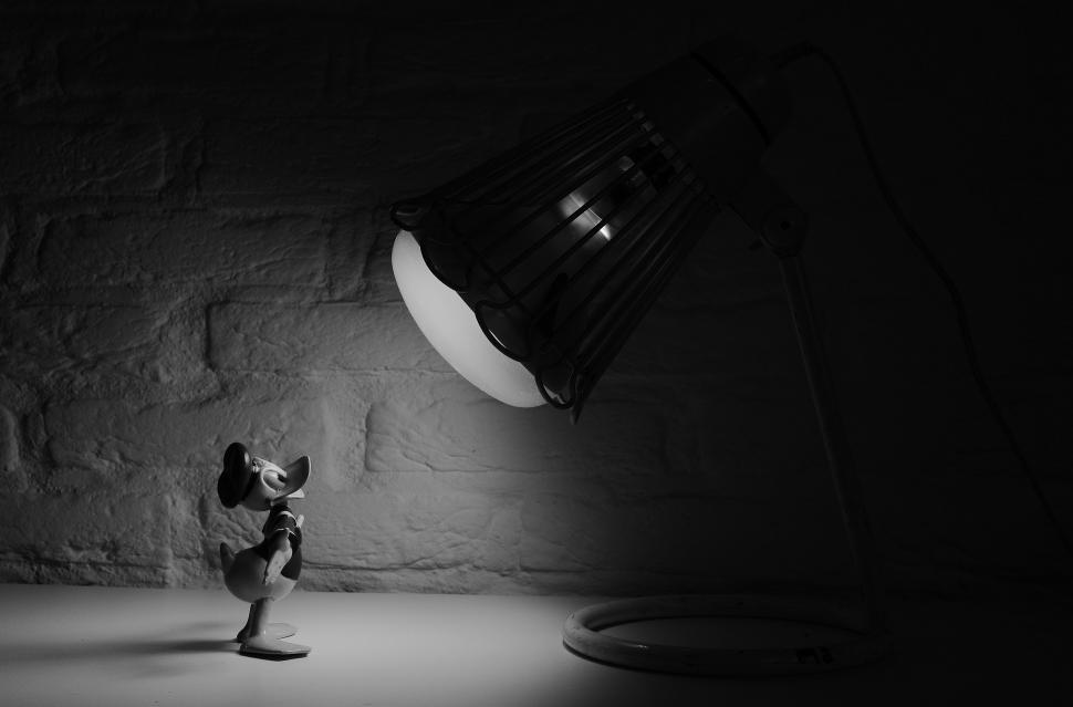 Free Image of A Black and White Photo of a Lamp in a Dark Room 