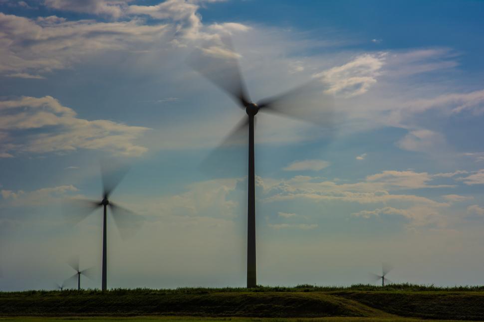 Free Image of Group of Windmills Standing in Grass 