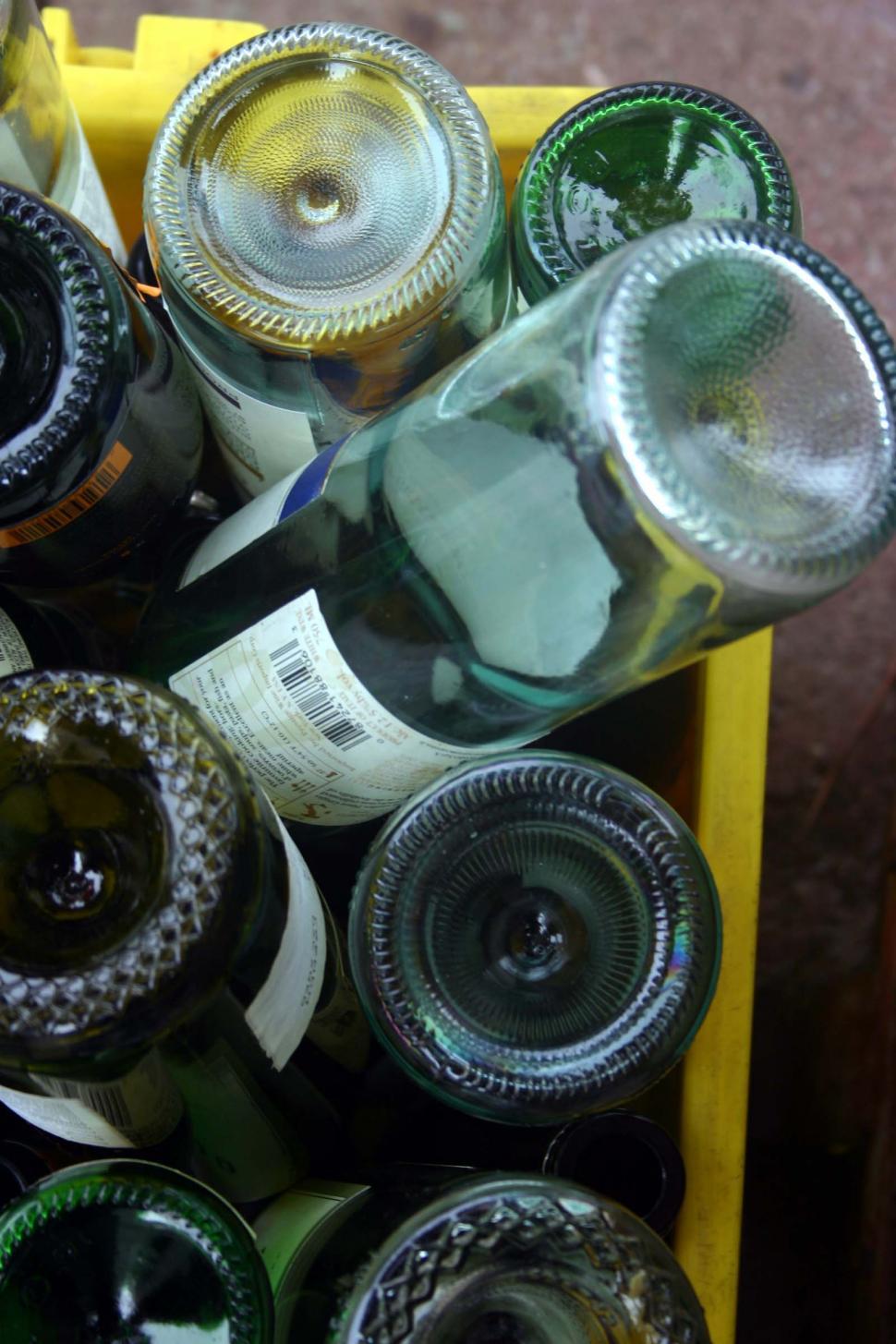 Free Image of Yellow Crate Filled With Empty Wine Bottles 