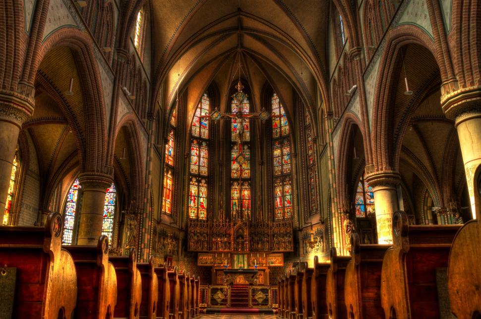 Free Image of Grand Cathedral With Stained Glass Windows and Pews 