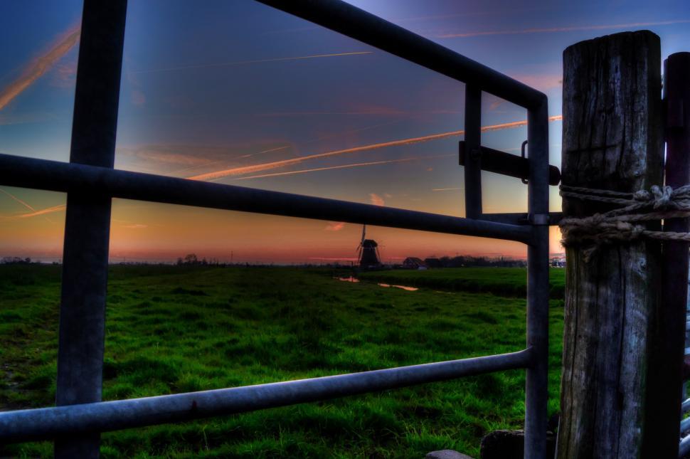 Free Image of Fence and Windmill in Grassy Field 