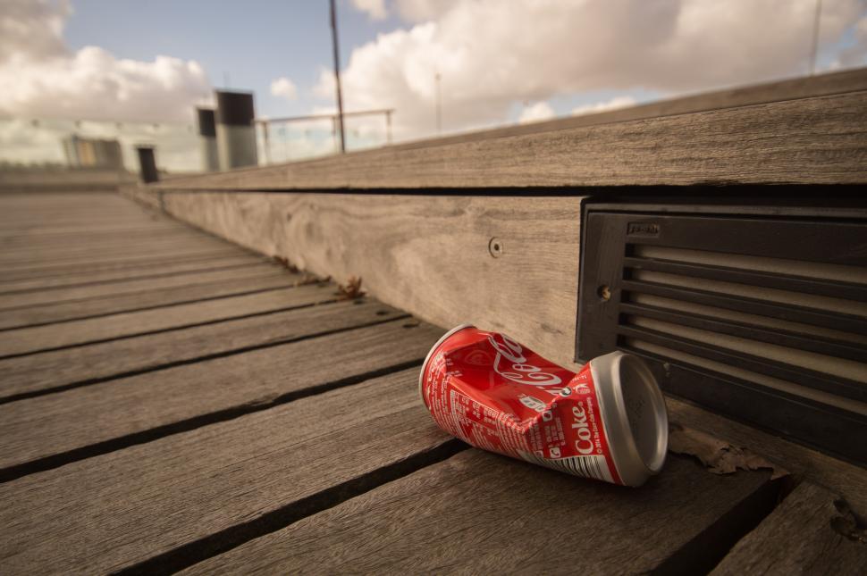 Free Image of Can of Coca Cola on Wooden Bench 