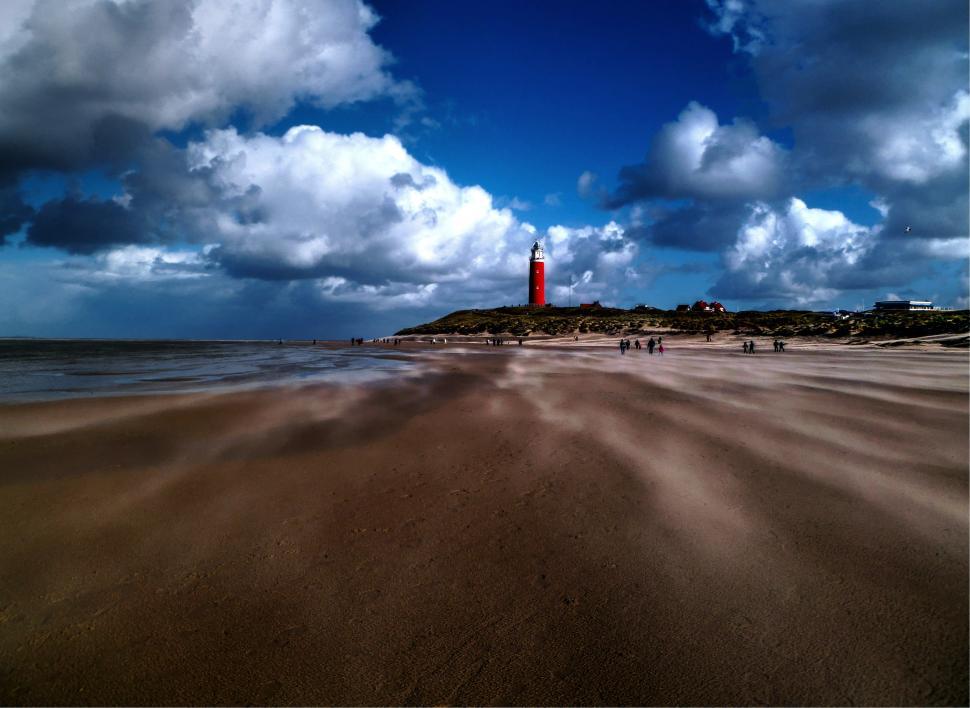 Free Image of Red Lighthouse on Sandy Beach 