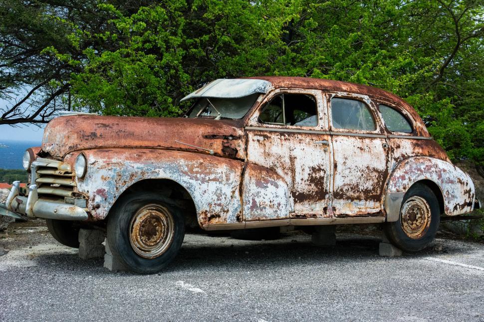 Free Image of Old Rusty Car in Parking Lot 