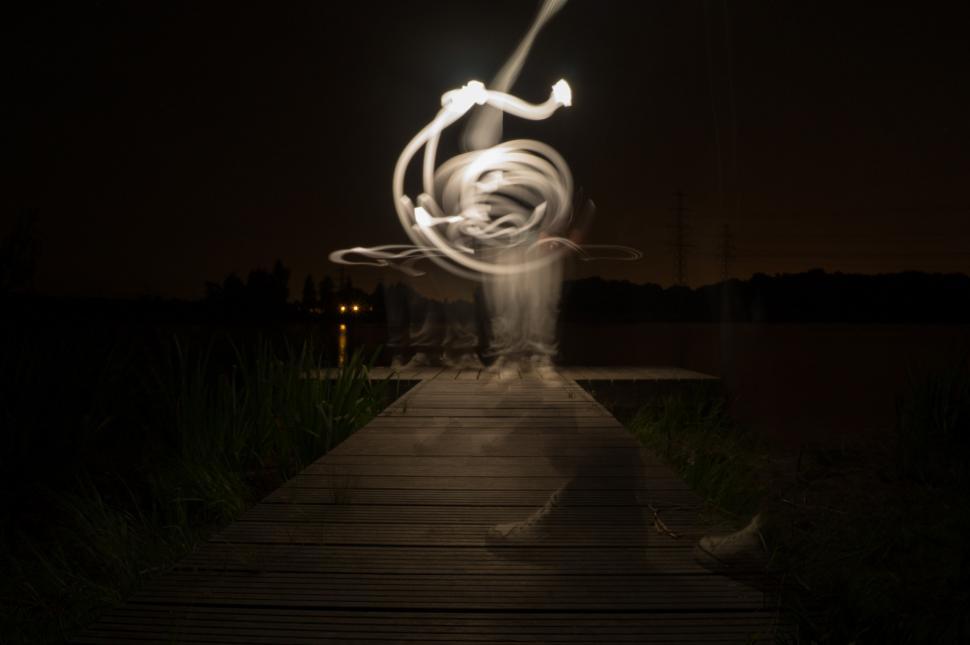 Free Image of Person Standing on Dock With Light Painting 