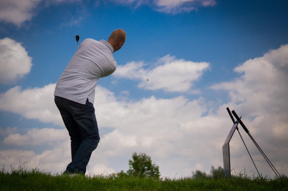 Free Image of Man Swinging Golf Club at Tee 