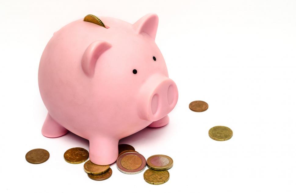 Free Image of Pink Piggy Bank on Top of Coin Pile 